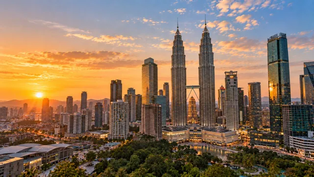 Petronas Towers above the Kuala Lumpur skyline at sunset