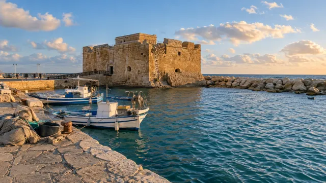 Paphos Castle and fishing boats in the sunlit harbour